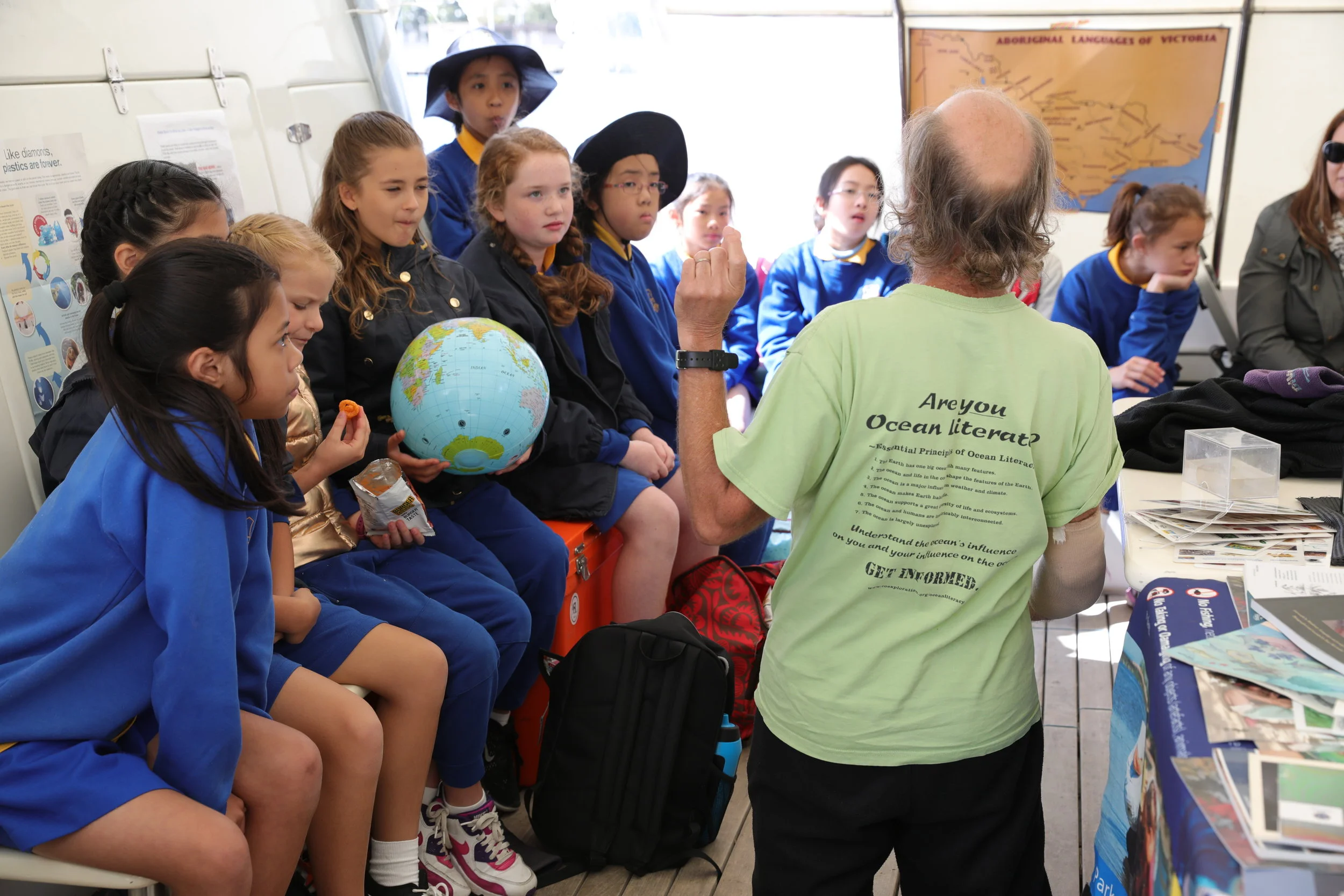 Ocean Literacy class with globe in field tent